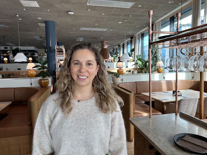 en kvinna står i en restaurangmiljö